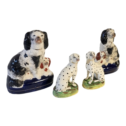 154 - A PAIR OF VICTORIAN STAFFORDSHIRE PEARLWARE MODELS OF DALMATIANS 
With painted features, gilt collar... 