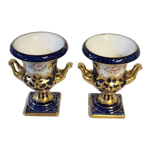 186 - A PAIR OF LATE 20TH CENTURY SEVRES STYLE TWIN HANDLED CAMPANA SHAPED JEWELLED VASES
Decorated with g... 