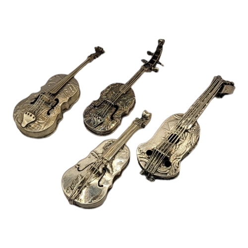 26 - A COLLECTION OF FOUR EARLY 20TH CENTURY SILVER NOVELTY CELLO
Having embossed figural decoration, unm... 