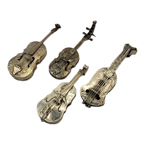 26 - A COLLECTION OF FOUR EARLY 20TH CENTURY SILVER NOVELTY CELLO
Having embossed figural decoration, unm... 