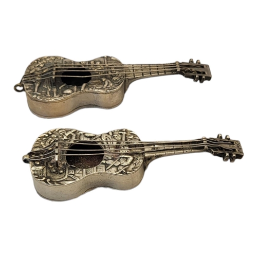 27 - A PAIR OF EARLY 20TH CENTURY DUTCH SILVER NOVELTY GUITARS
Having embossed figural decoration.
(appro... 