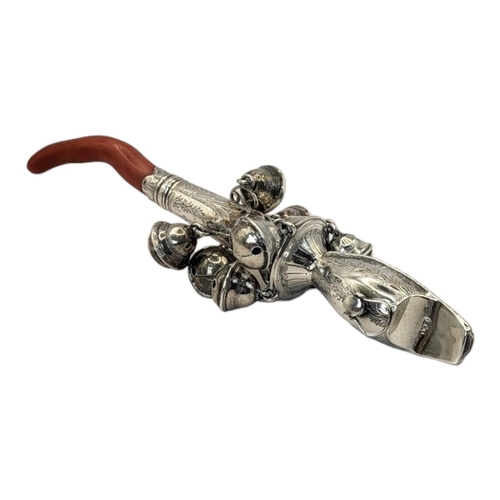 45 - A GEORGIAN SILVER AND CORAL CHILD'S RATTLE
Having a whistle finial, eight bells, engraved decoration... 