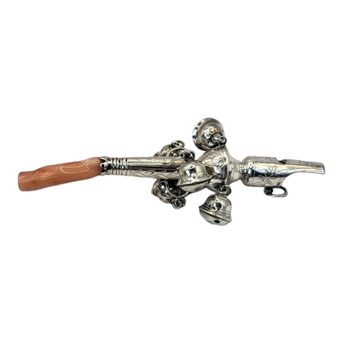 46 - A GEORGIAN  SILVER AND CORAL CHILD'S RATTLE
Having a whistle finial, six bells, engraved decoration ... 