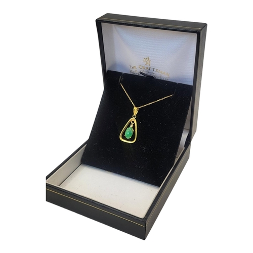 51 - A VINTAGE 14CT GOLD AND JADE PENDANT NECKLACE
An oval cut stone in a triangular mount, on a fine lin... 