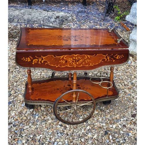 503 - AN ITALIAN MID CENTURY MAHOGANY AND BRASS  INLAID DRINKS TROLLEY
Having pierced brass gallery,inlaid... 