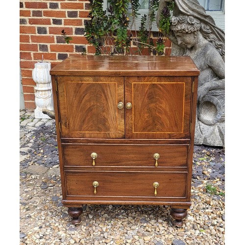 511 - A REGENCY PERIOD WALNUT VENEER COMMODE
The string inlay facade with drop handles covers a later conv... 