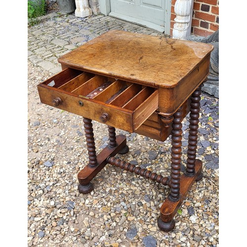 508 - A 19TH CENTURY BURR WALNUT SEWING TABLE
The compartmental drawer above a lined storage box, on bobbi... 