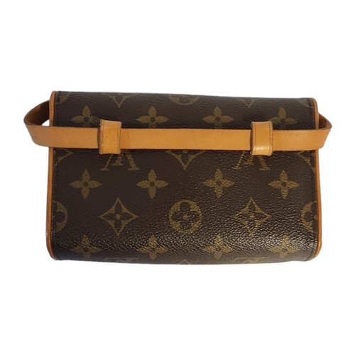 214 - LOUIS VUITTON, A VINTAGE BROWN LEATHER CLUTCH PURSE
Having a single handle and  LV monogram, in a LV... 