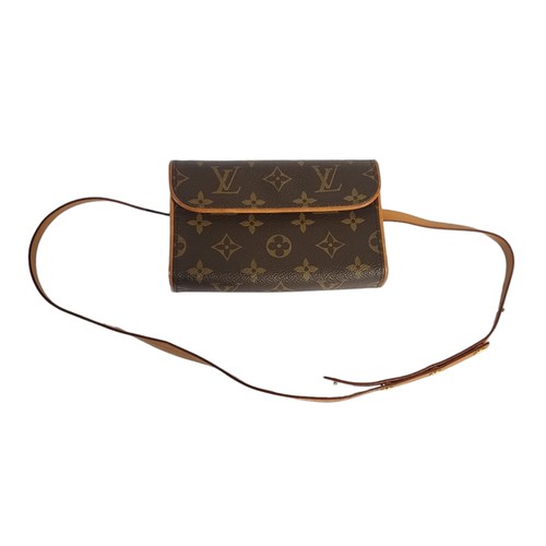 214 - LOUIS VUITTON, A VINTAGE BROWN LEATHER CLUTCH PURSE
Having a single handle and  LV monogram, in a LV... 