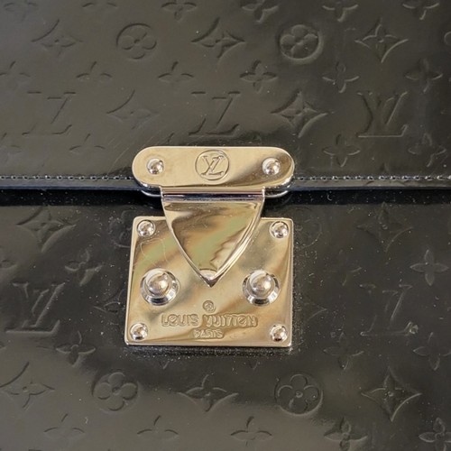 217 - LOUIS VUITTON, A BLACK LEATHER HANDBAG
Having a single handle and LV monogram design, in a brown fab... 