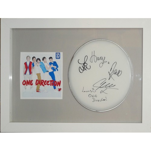 417 - ONE DIRECTION, AN ORIGINAL AUTOGRAPHED DRUM SKIN
Signed by Harry Styles and all members, in a fitted... 