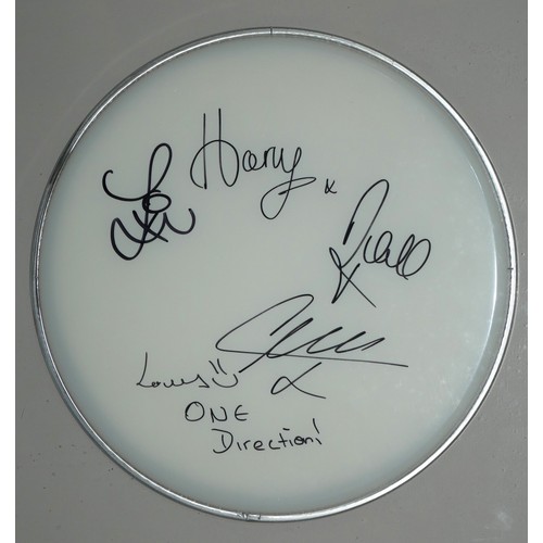 417 - ONE DIRECTION, AN ORIGINAL AUTOGRAPHED DRUM SKIN
Signed by Harry Styles and all members, in a fitted... 