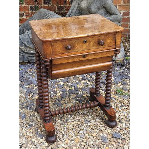 508 - A 19TH CENTURY BURR WALNUT SEWING TABLE
The compartmental drawer above a lined storage box, on bobbi... 