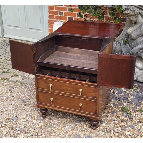 511 - A REGENCY PERIOD WALNUT VENEER COMMODE
The string inlay facade with drop handles covers a later conv... 