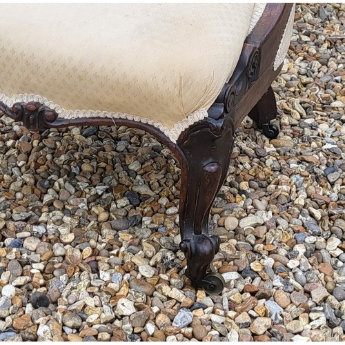 515 - A VICTORIAN ROSEWOOD LOW CHAIR
Having cream upholstery with scrolled back and carved cabriole legs o... 