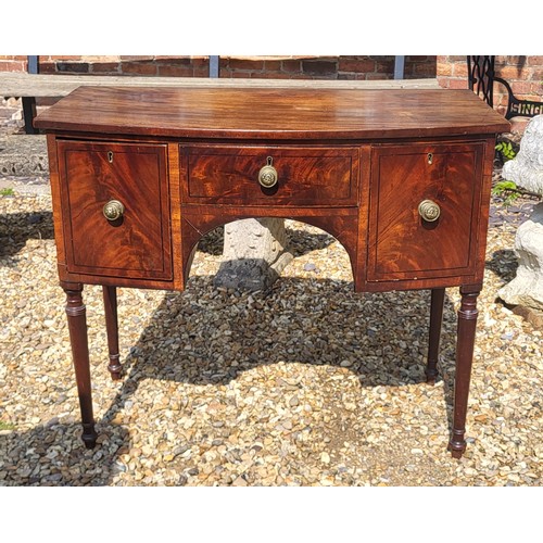 523 - A GEORGIAN MAHOGANY BOW FRONTED SIDE CABINET
Of small proportions with three drawers, on ring turned... 