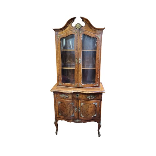 525 - A 19TH CENTURY DUTCH FIGURED WALNUT SIDE CABINET
Applied with decorative brass mounts, the swan neck... 