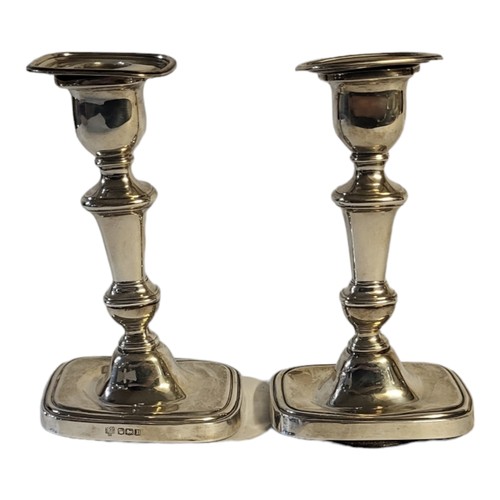 60 - A PAIR OF EARLY 20TH CENTURY SILVER CANDLESTICKS
Rectangular form with stepped base, hallmarked Hawk... 