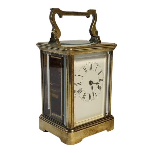 234 - AN EARLY 20TH CENTURY GILT BRASS CORNICHE CASED CARRIAGE CLOCK
The eight day movement, white enamel ... 