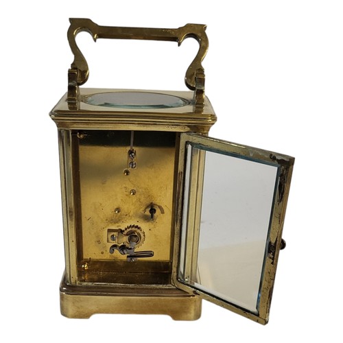 234 - AN EARLY 20TH CENTURY GILT BRASS CORNICHE CASED CARRIAGE CLOCK
The eight day movement, white enamel ... 