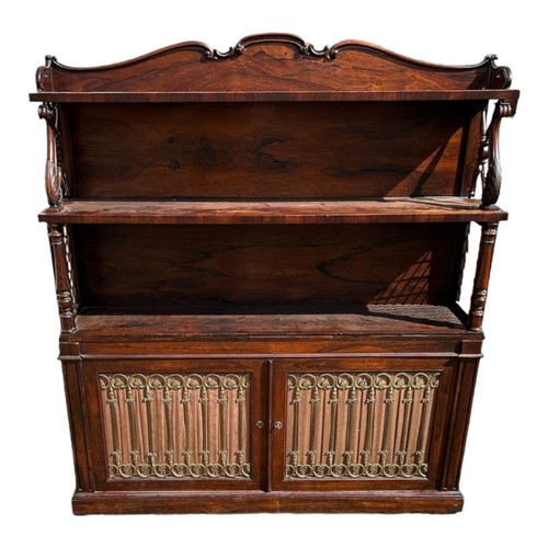 572 - A WILLIAM IV PERIOD ROSEWOOD BOOKCASE
With serpentine shaped top rail above open shelves supported o... 