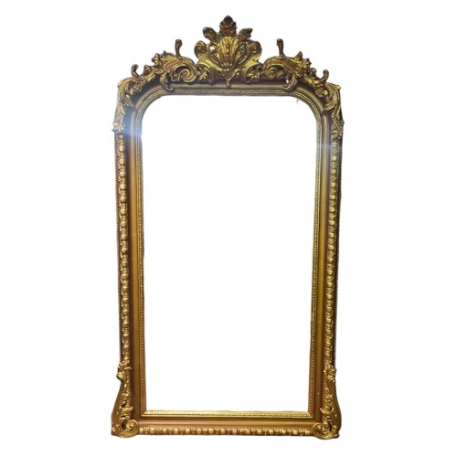 574 - A LARGE 19TH CENTURY STYLE GILT FRAMED MIRROR
With organic crest cartouche above a bevelled plate.
(... 