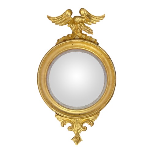 548 - A REGENCY PERIOD GILTWOOD FRAMED CONVEX MIRROR
Eagle mounted, above plate, and carved cartouche.
(64... 