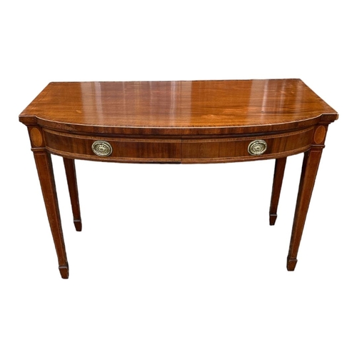 552 - A 19TH CENTURY SHERATON DESIGN MAHOGANY AND SATINWOOD BOW FRONTED SIDE TABLE
With two drawers, on sq... 