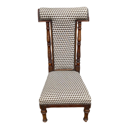 553 - A LATE VICTORIAN BEECHWOOD PRAYER CHAIR
In later fabric upholstery, on turned legs terminating on wh... 