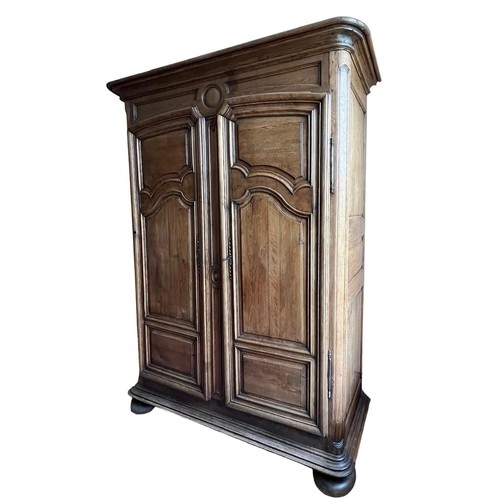 566 - A LARGE 18TH CENTURY FRENCH OAK ARMOIRE 
Wth shaped panelled doors opening to reveal shelf interior ... 