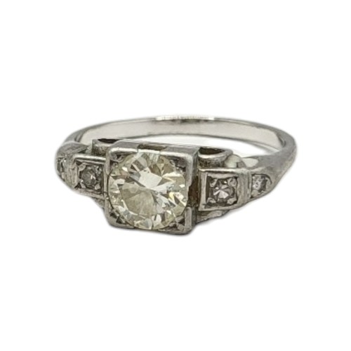 140 - AN EARLY 20TH CENTURY WHITE METAL AND DIAMOND RING
The central round cut diamond in a square form st... 