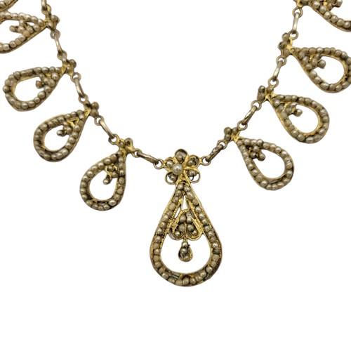 147 - AN EARLY 20TH CENTURY CONTINENTAL SILVER GILT AND SEED PEARL FILIGREE NECKLACE
The graduated row of ... 