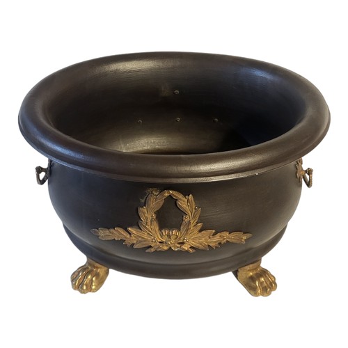 354 - AN EARLY 20TH CENTURY EMPIRE STYLE METAL BLACK PATINATED TUREEN SHAPE TWIN HANDLED URN/JARDINIERE
Th... 