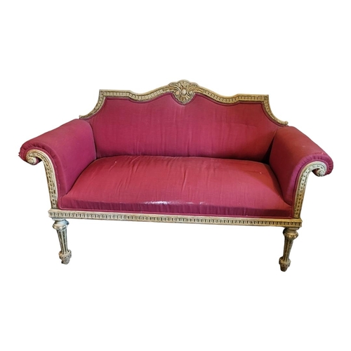 593 - A 19TH CENTURY CHIPPENDALE DESIGN PARCEL GILT AND PAINTED TWO SEAT SETTEE
The serpentine top rail ce... 