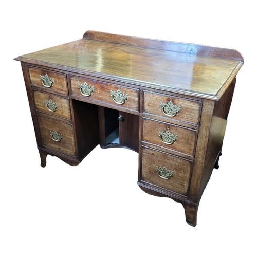 594 - AN EARLY VICTORIAN SOLID MAHOGANY KNEEHOLE DESK
Having an arrangement of seven drawers fitted with p... 