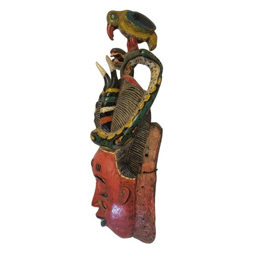 188A - A 20TH CENTURY AFRICAN TRIBAL CARVED WOODEN 'GURO' MASK
Having an exotic bird and snake finials with... 