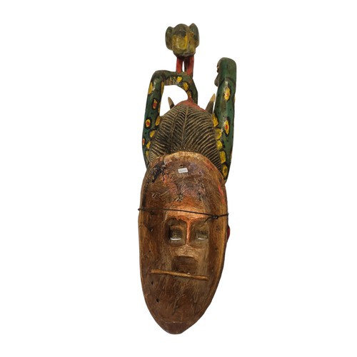 188A - A 20TH CENTURY AFRICAN TRIBAL CARVED WOODEN 'GURO' MASK
Having an exotic bird and snake finials with... 