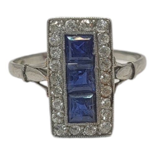 15A - AN ART DECO WHITE METAL, SAPPHIRE AND DIAMOND RING
Three square cut sapphires edged with round cut d... 