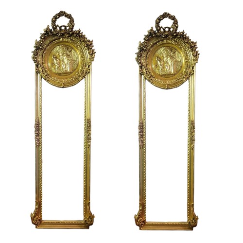 381 - A PAIR OF ART NOUVEAU DESIGN GILT FRAMED MIRRORS
With floral cartouche above female portraits and be... 