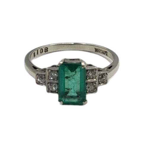 30A - AN ART DECO 18CT WHITE GOLD, DIAMOND AND EMERALD RING
The central baguette cut emerald, with round c... 