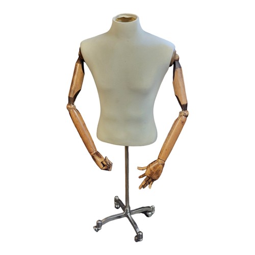 590 - A VINTAGE TAILOR’S DUMMY
With calico covered, body wooden articulated arms, on chrome base.
(130cm)