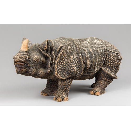 367 - A CARVED HARDWOOD RHINOCEROS SCULPTURE.
(l 44.5cm)