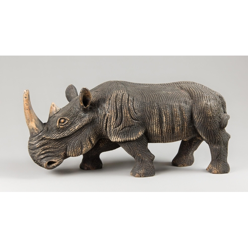 376 - A CARVED HARDWOOD RHINOCEROS SCULPTURE.
(l 44.5cm)