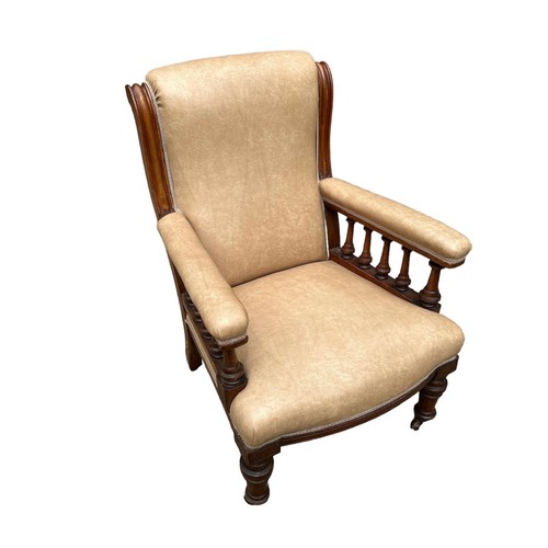 359 - A VICTORIAN MAHOGANY GENTLEMANS ARMCHAIR
In later faux leather upholstery, turned spindles, on turne... 