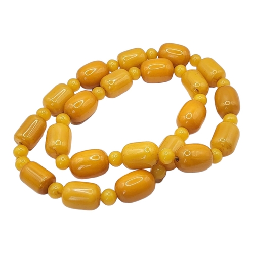 31 - A VINTAGE BUTTERSCOTCH RECTANGULAR AMBER NECKLACE 
Beads with spherical spacers links, together with... 
