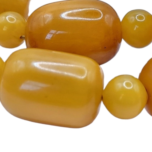31 - A VINTAGE BUTTERSCOTCH RECTANGULAR AMBER NECKLACE 
Beads with spherical spacers links, together with... 