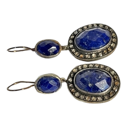 43 - A PAIR OF WHITE METAL DIAMOND AND LAPIS LAZULI EARRINGS 
Having a cabochon cut lapis stone edged wit... 