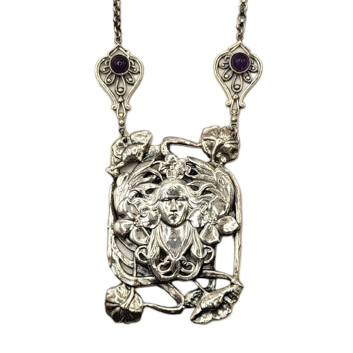 46 - AN ART NOUVEAU STYLE STERLING SILVER AMETHYST NECKLACE
The central portrait of a woman surrounded by... 