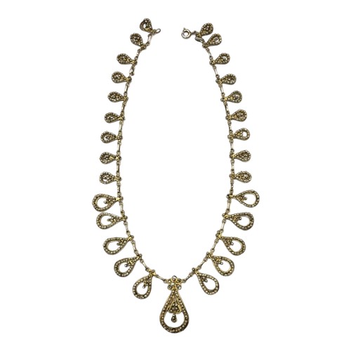 59 - AN EARLY 20TH CENTURY CONTINENTAL SILVER GILT AND SEED PEARL FILIGREE NECKLACE
The graduated row of ... 