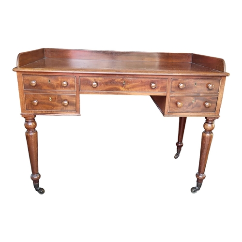 360 - A VICTORIAN MAHOGANY DRESSING/WRITING TABLE 
With galleried back above an arrangement of five drawer... 